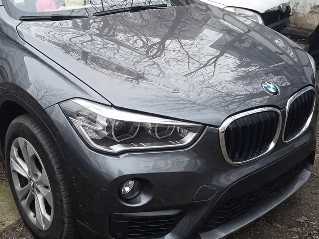 BMW X1 gri cu fața refăcută, cu bară, faruri și grilă noi, după reparație în atelierul GSC